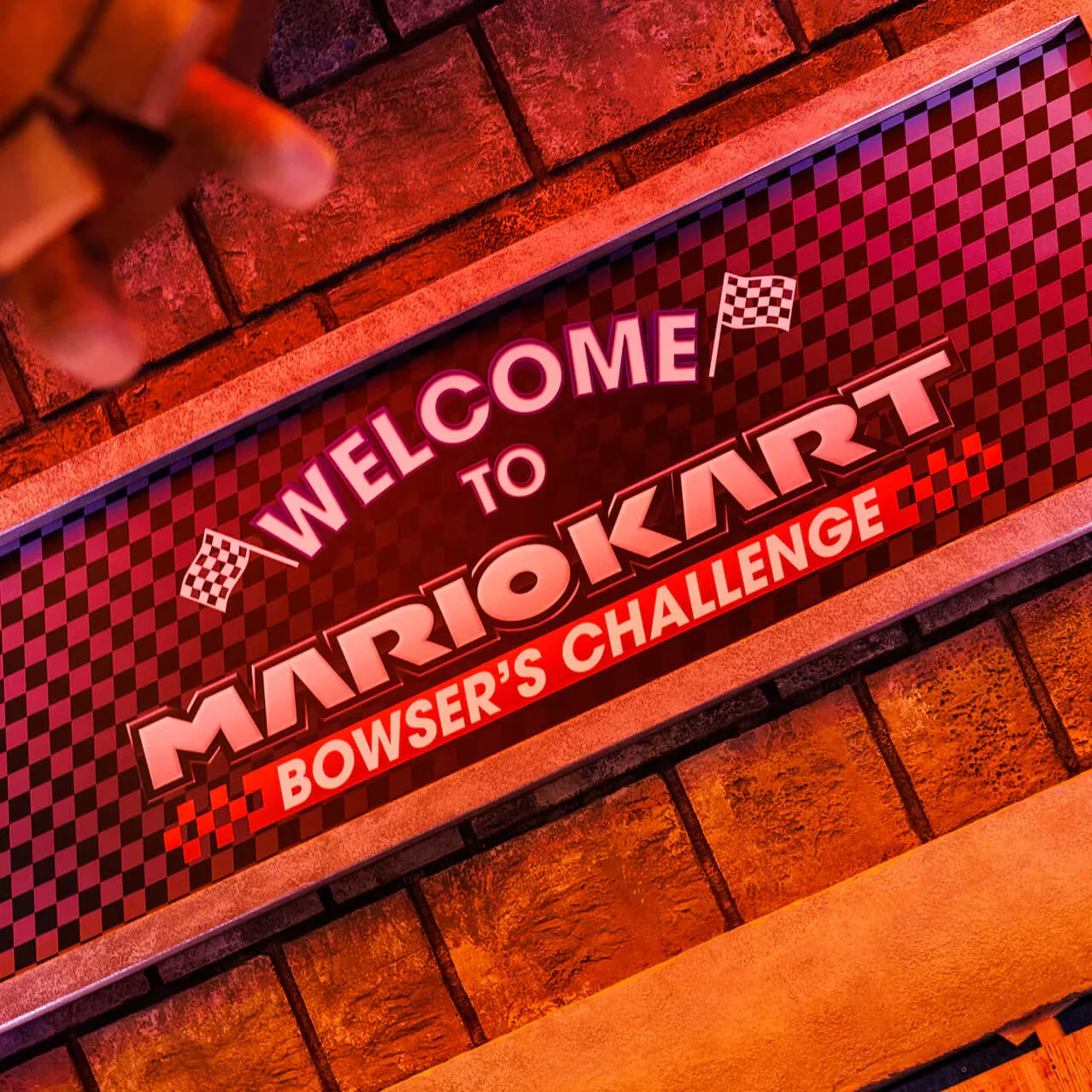 Welcome banner for the Mario Kart ride with checkered flag lettering