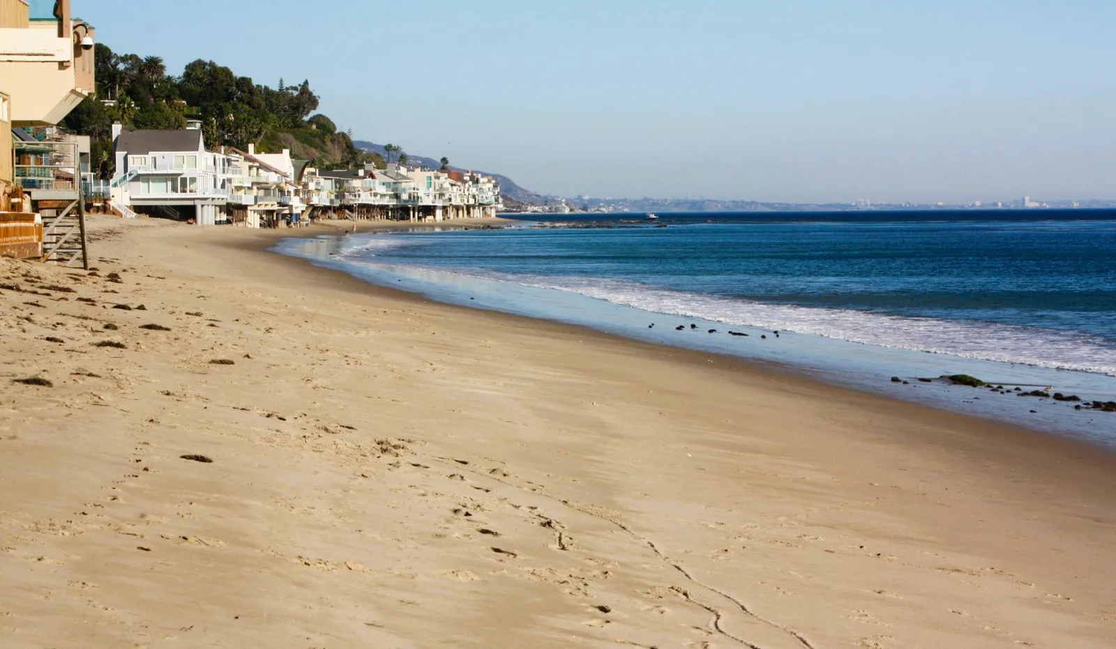 Empty sand and footprints along a quiet Malibu shoreline