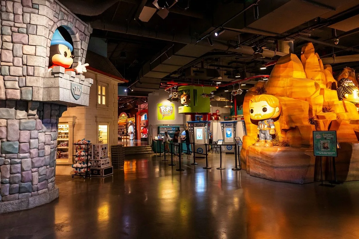 Store interior with a castle facade, oversized character figures and polished floors