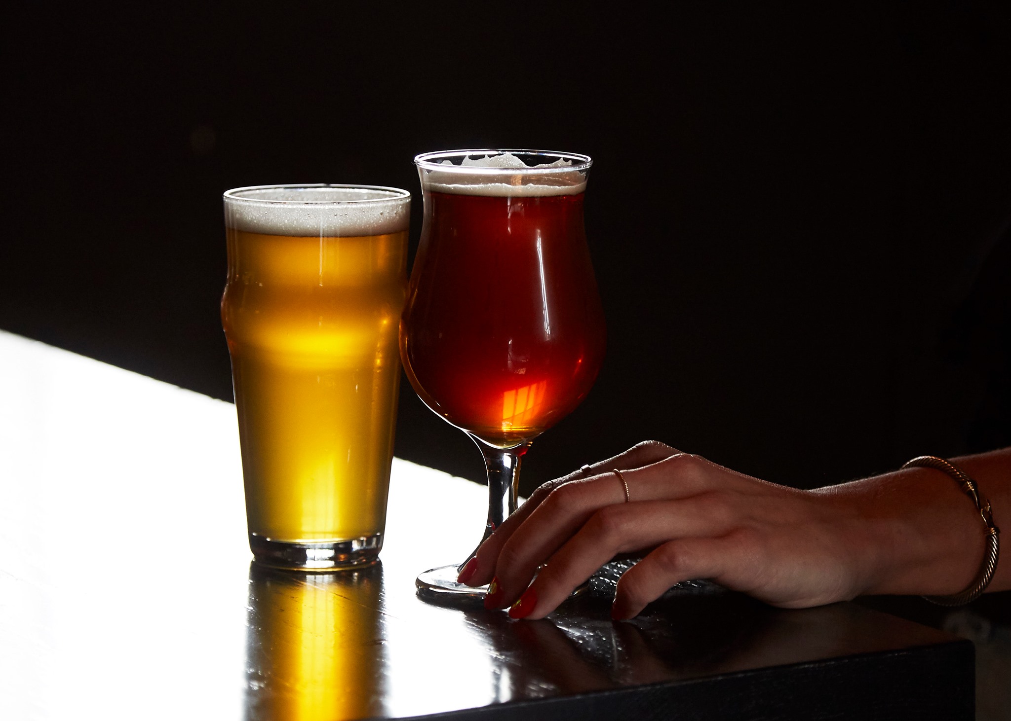 Bar, taps and neon logo at Arts District Brewing Company