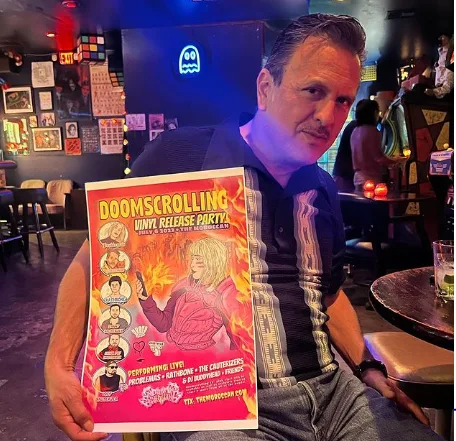 A patron at Blipsy Bar holding a vinyl record