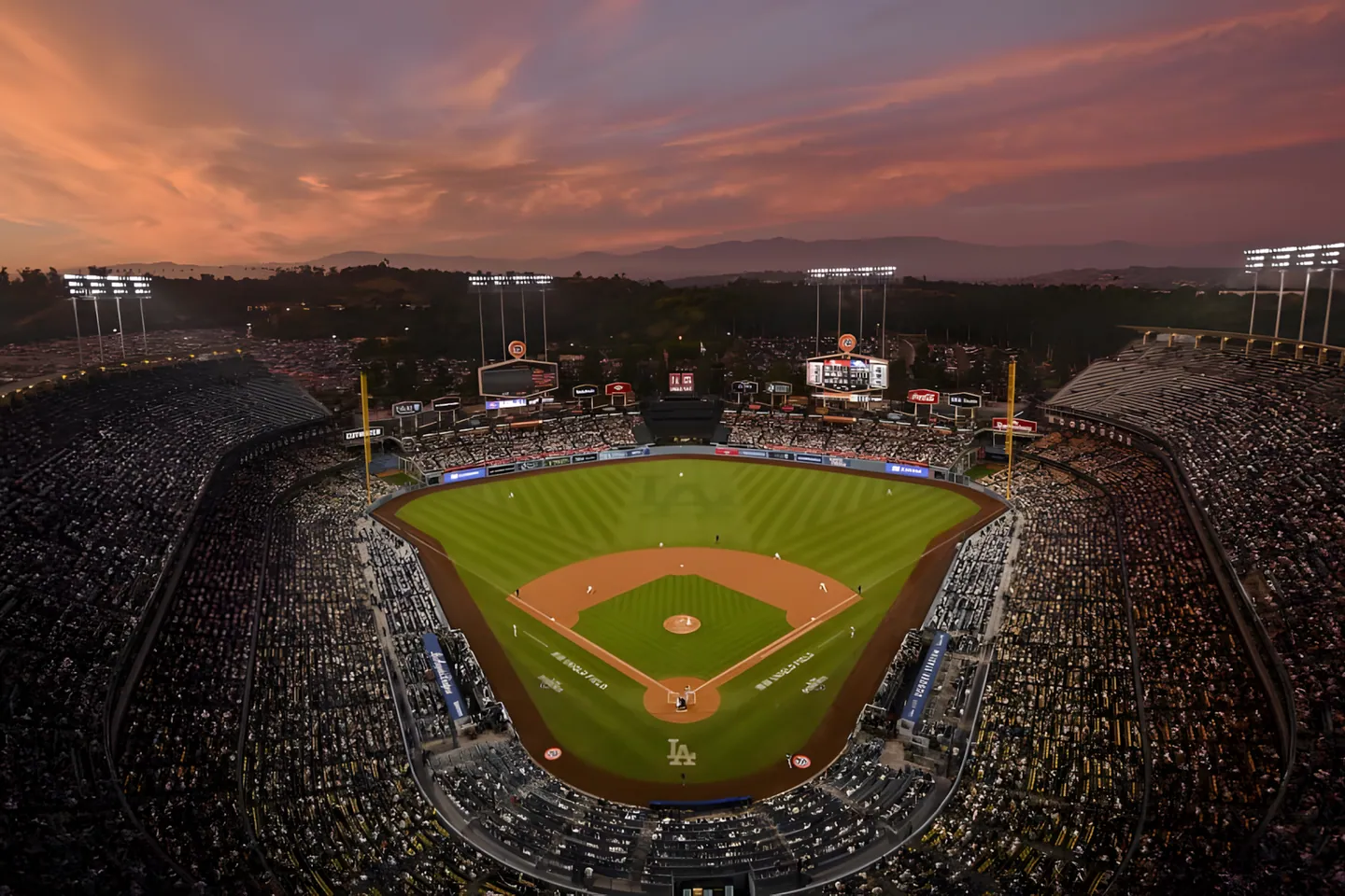 Dodger Stadium at dusk with the San Gabriel Mountains behind