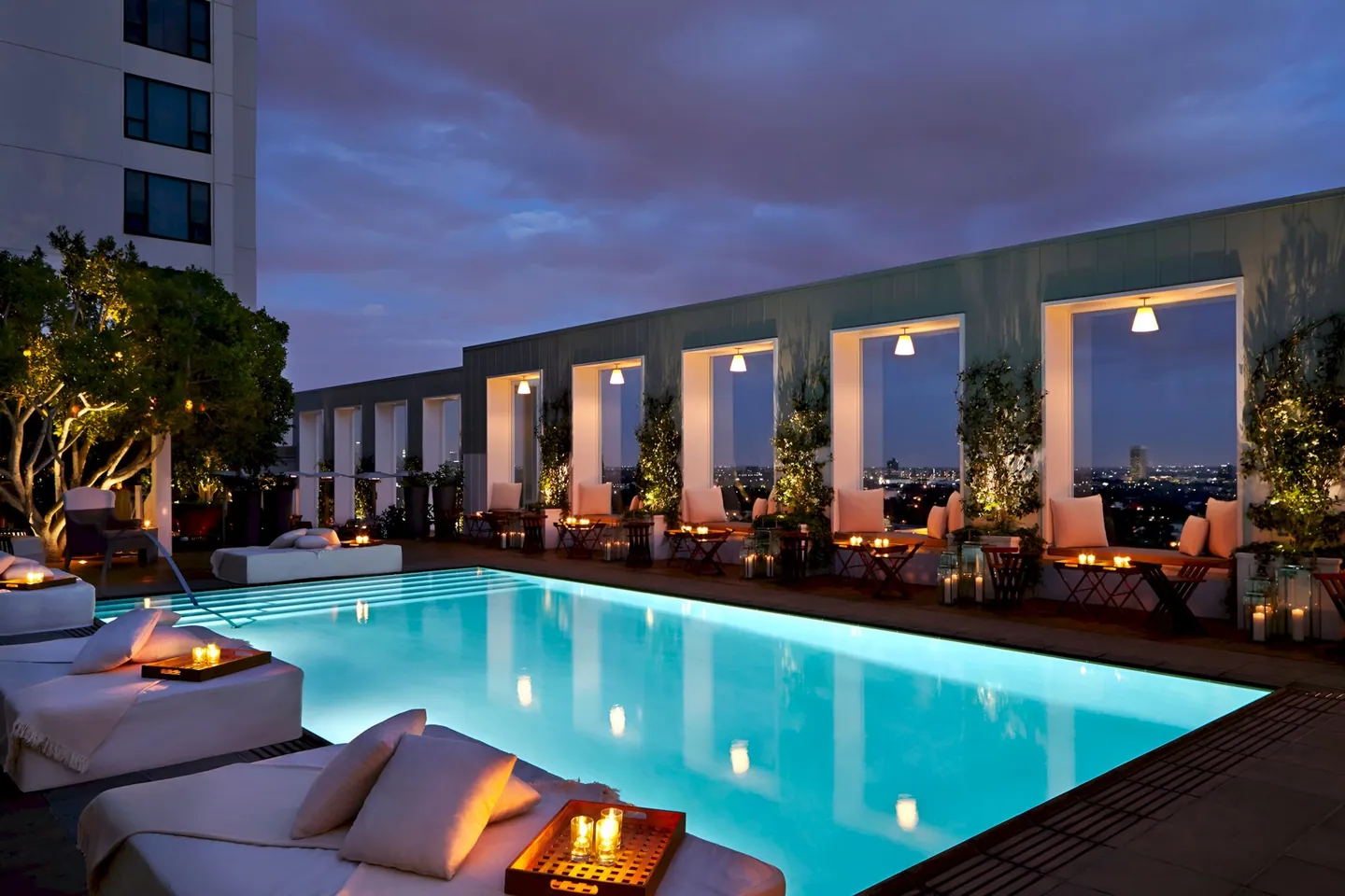 A hotel rooftop pool in Los Angeles on a clear afternoon