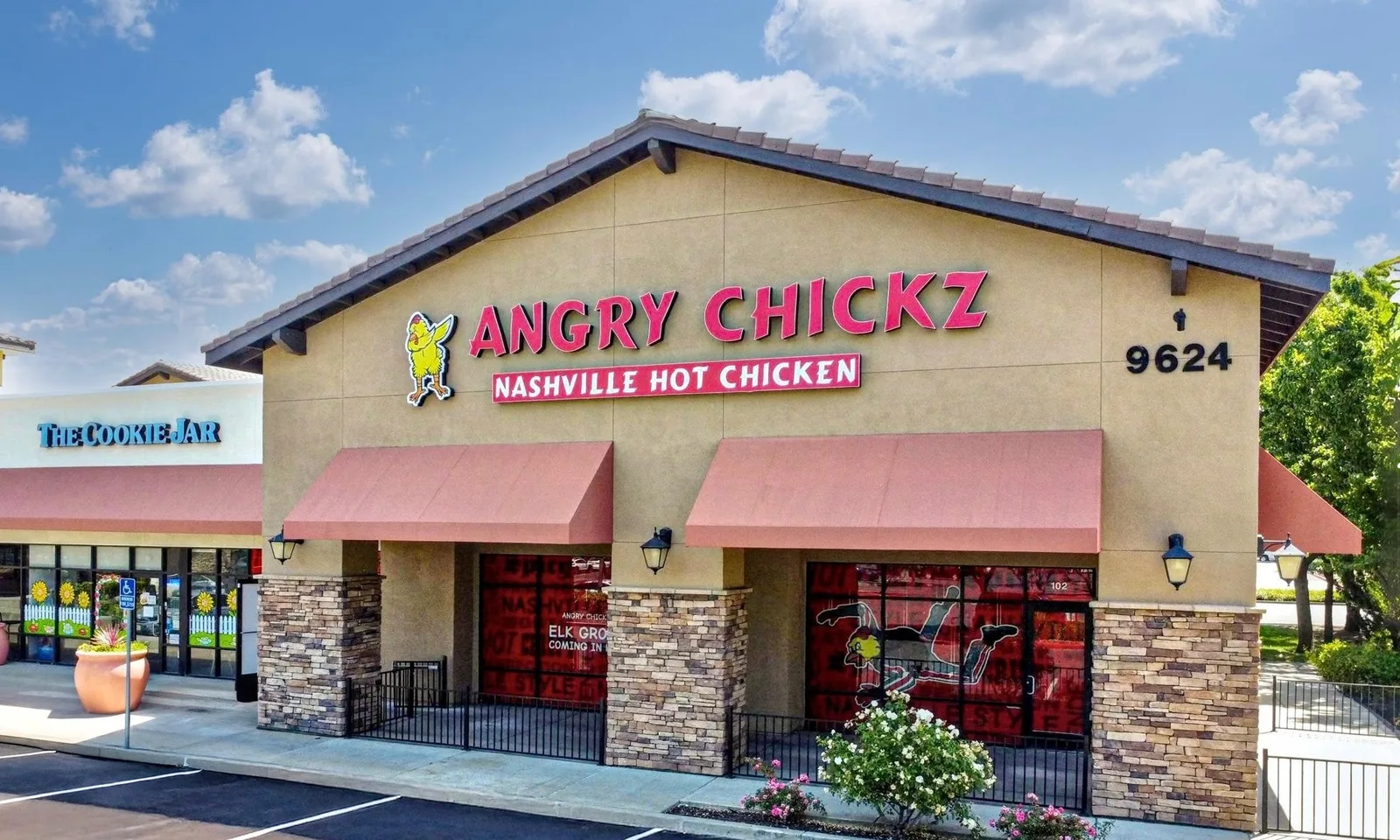 ANGRY CHICKZ Nashville Hot Chicken storefront with pink awnings under blue sky