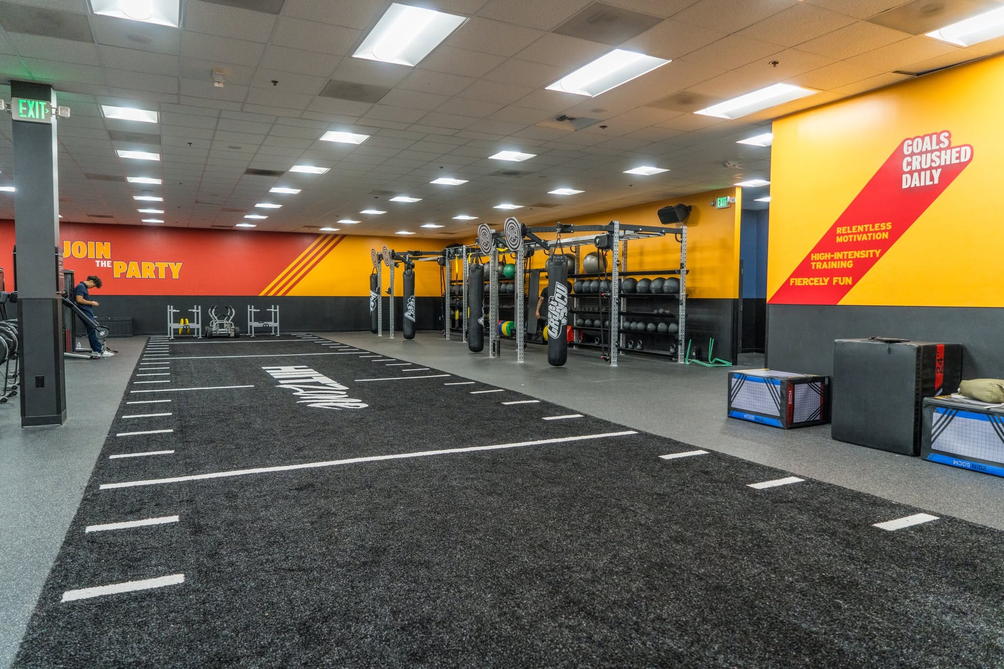 The orange and black-branded workout floor at Crunch Fitness