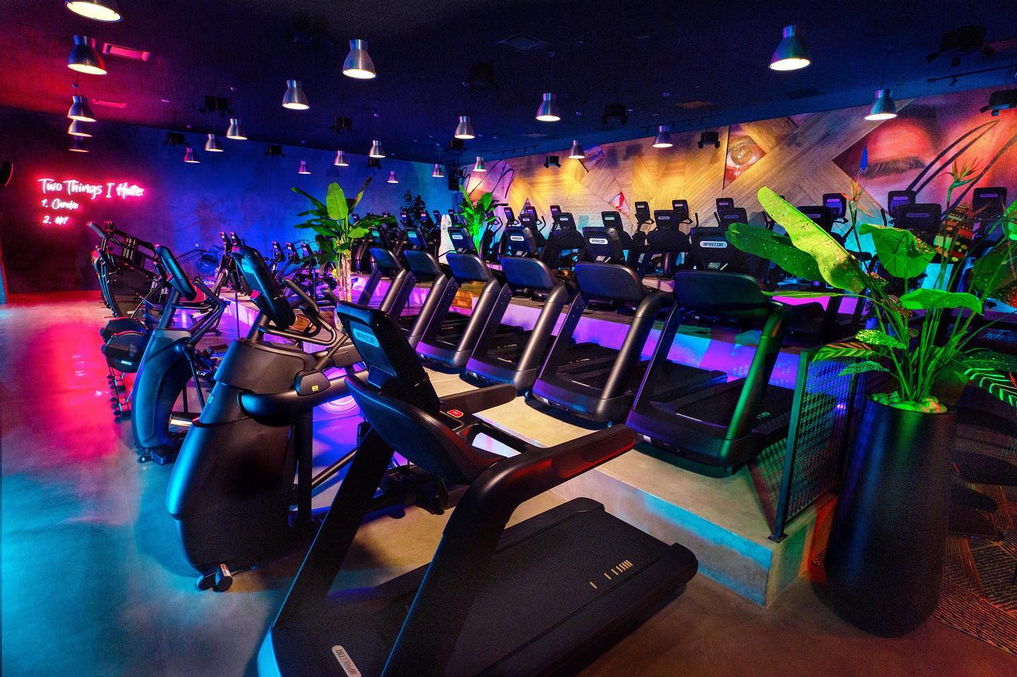 The colorful workout floor inside a John Reed Fitness club