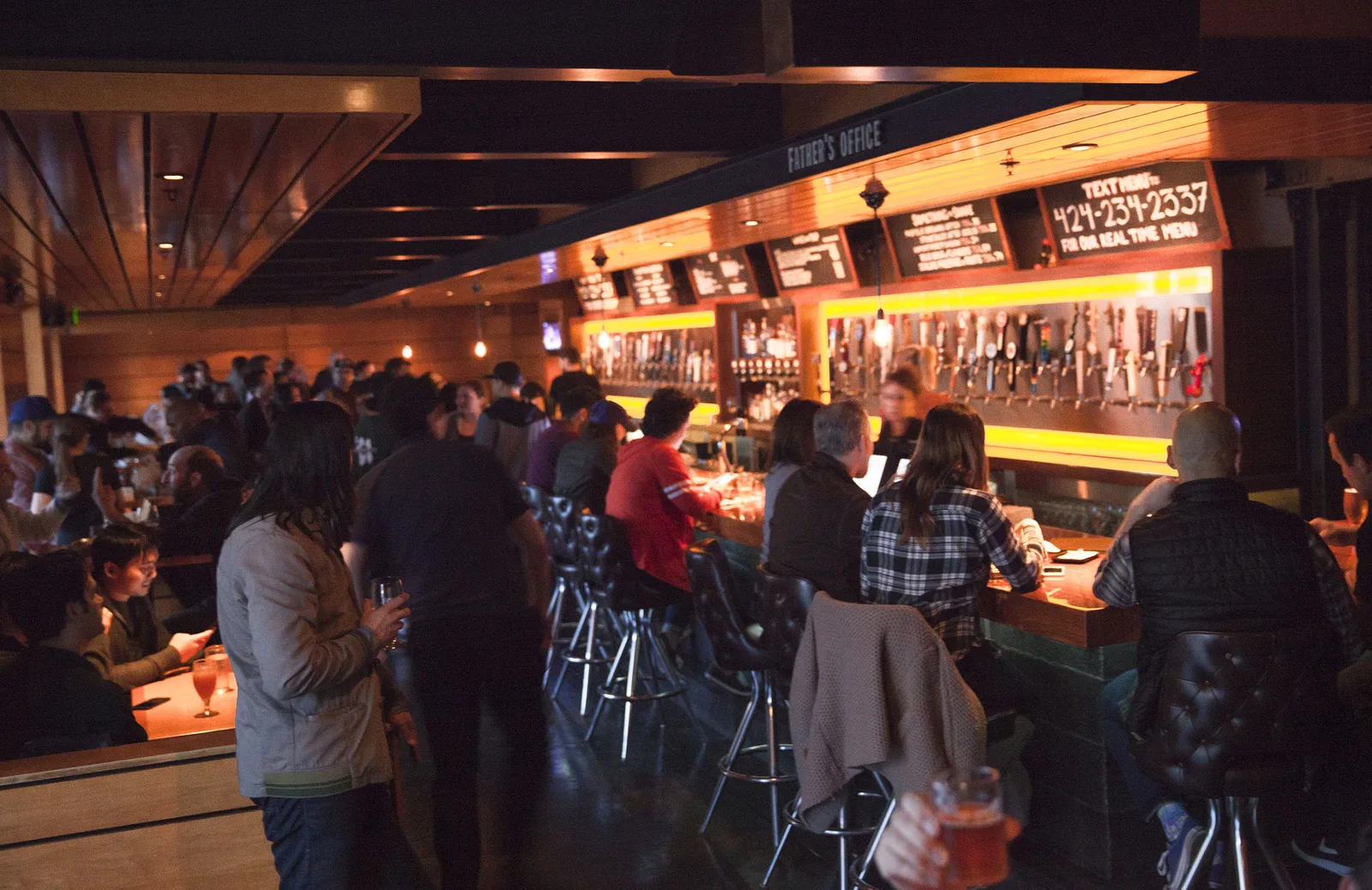Father's Office's famous Office Burger with fries and a craft beer at the Culver City gastropub in Los Angeles.