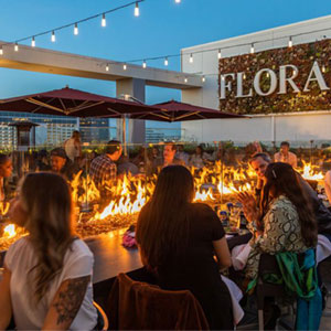 Flora Rooftop Bar and Lounge lit up at night with garden greenery, El Segundo