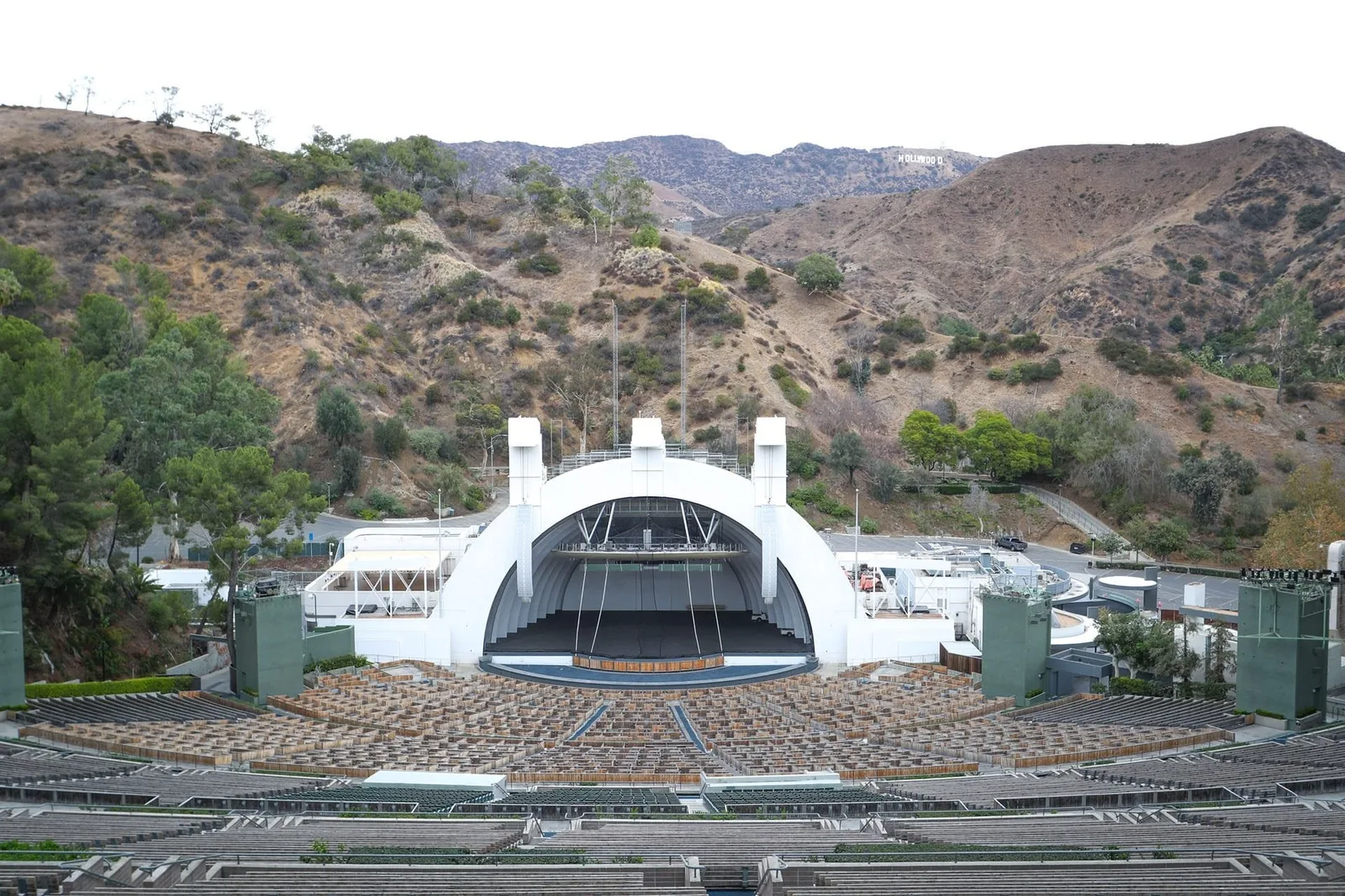 Shell shaped bandshell and tiered seating against dry hillsides