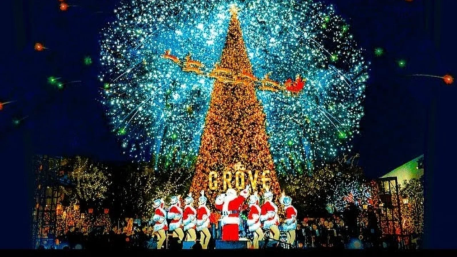A singing Santa and dancers perform in front of the massive Christmas Tree at The Grove