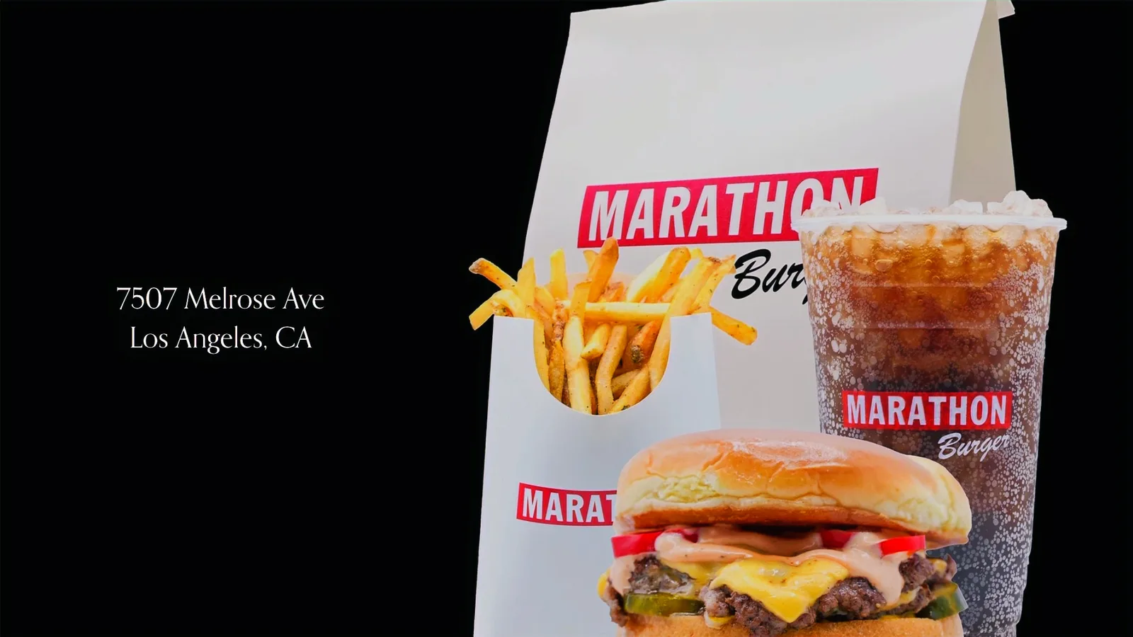 Marathon Burger takeout bag with drink and fries on a black background