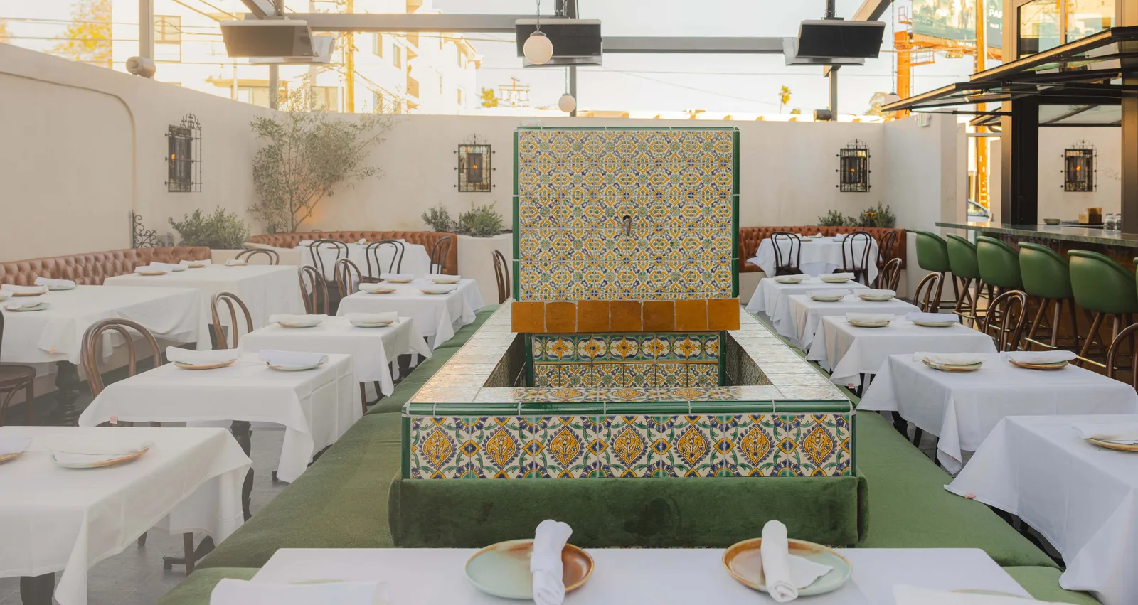 Banquet hall with long white clothed tables flanking a tiled fountain