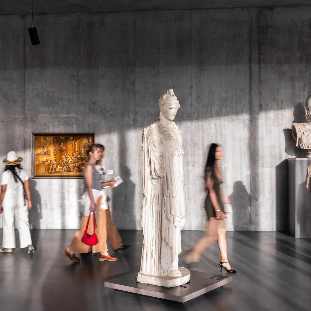 Visitors walking among classical sculpture in a Getty gallery