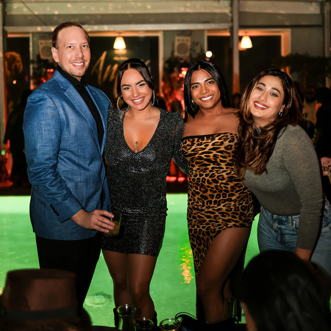 Editor-in-Chief of LA Today with VIP guests at their poolside table in Hollywood.
