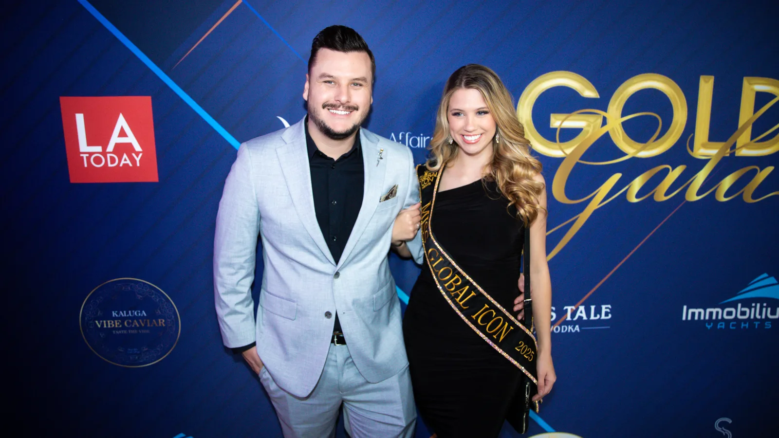 Miss Global Icon gets her photo taken on the golden carpet by press photography and media.