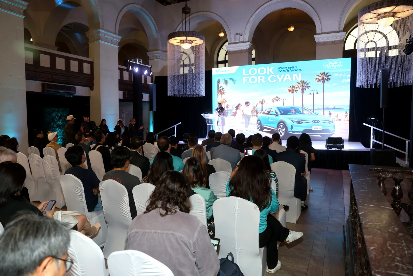 Guests seated at the Green SM Los Angeles launch at The Majestic Downtown, facing a Look for Cyan stage screen