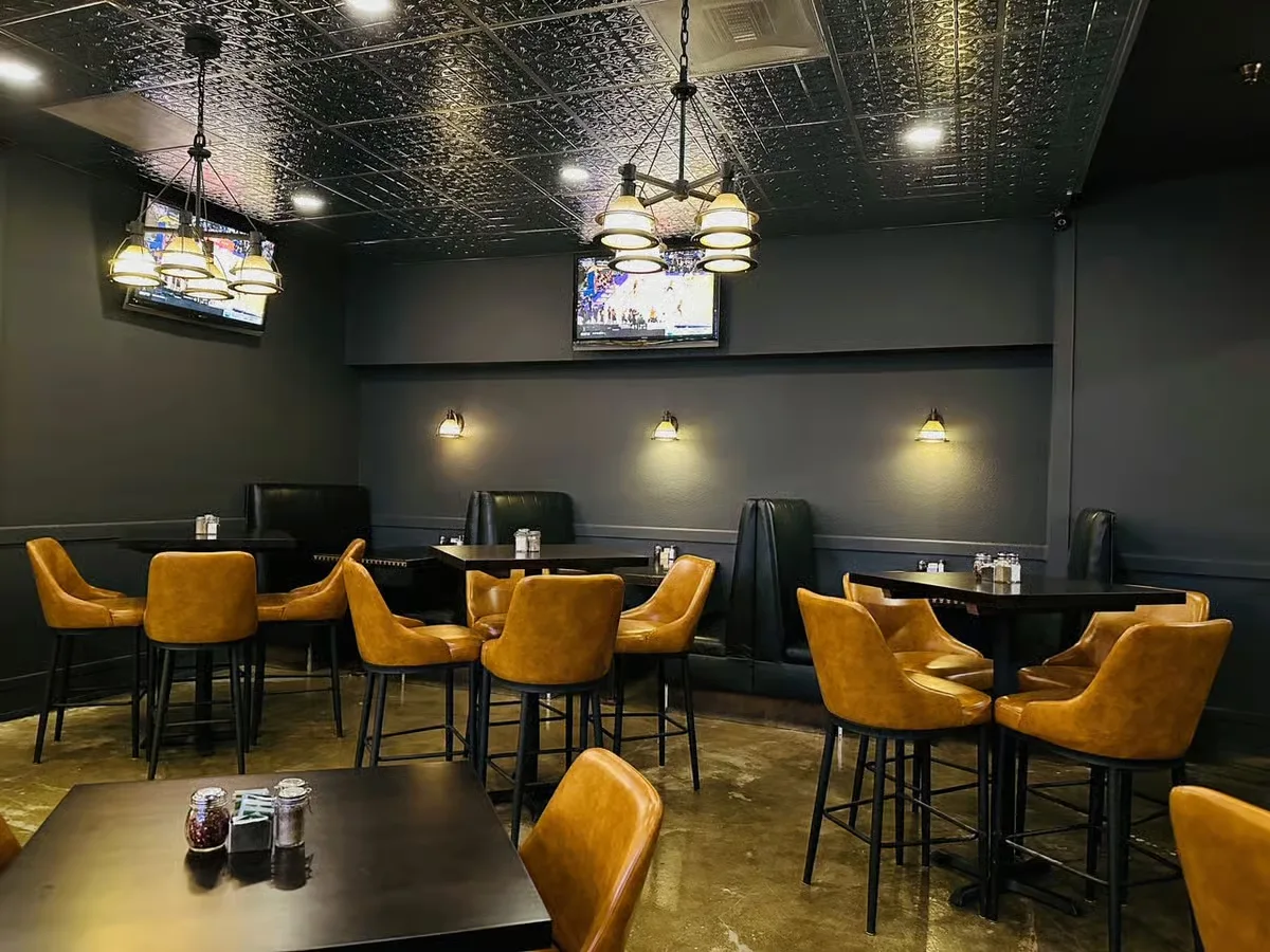 Dim restaurant interior with booth seating and pendant lights