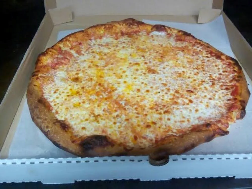 Cheese pizza sitting in an open takeout box