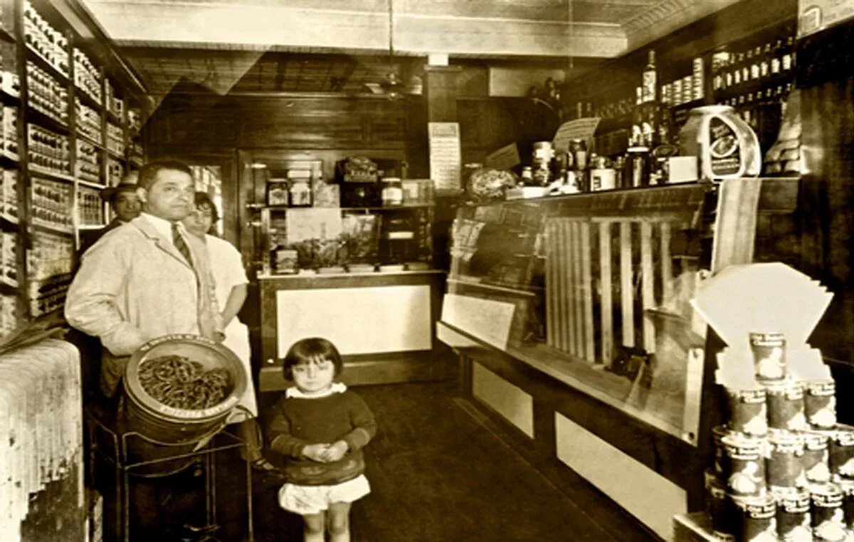 Sepia archival shot of a man holding a pan beside a child