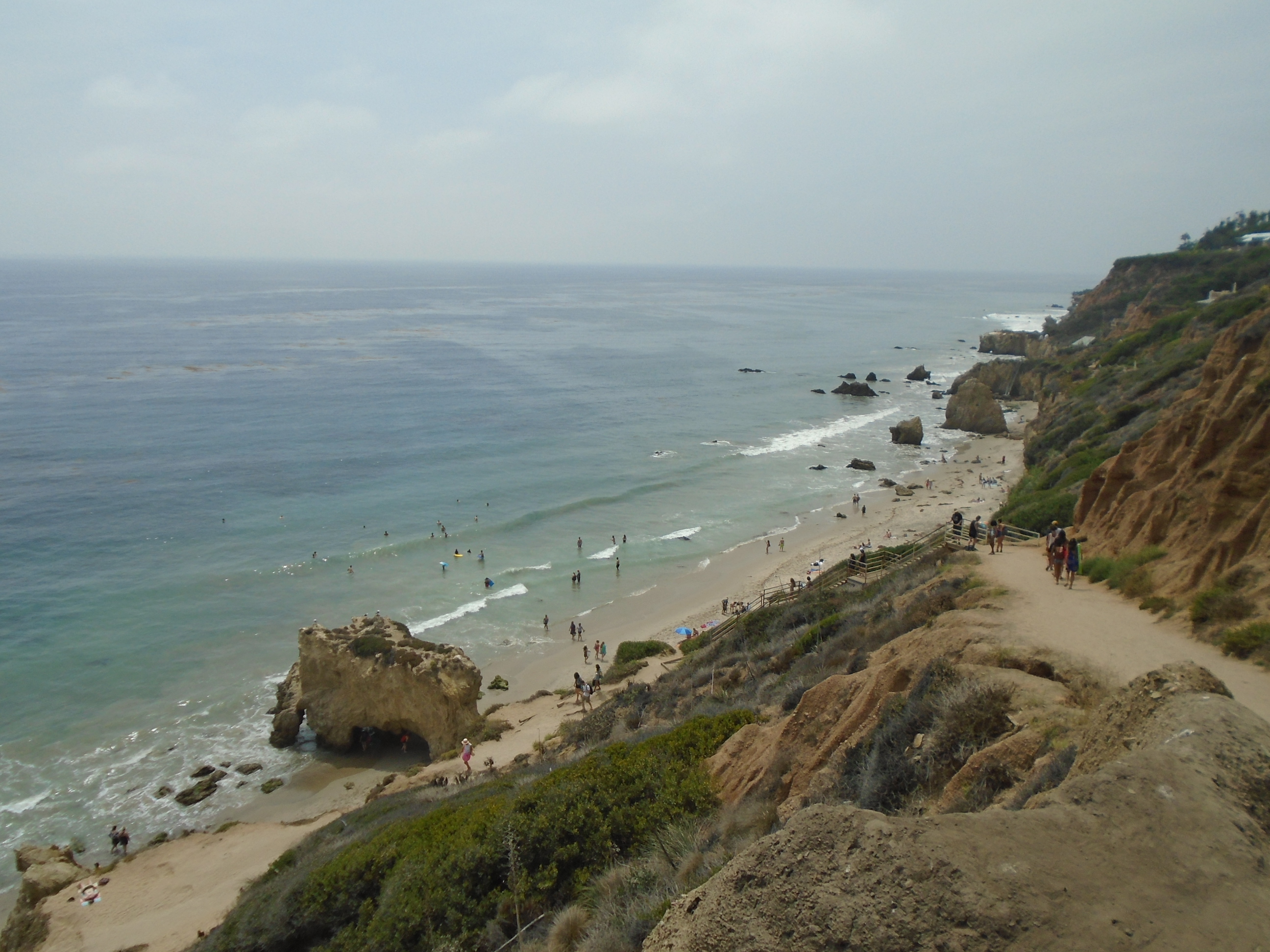 Dramatic sea stacks, arches and cliffs rising from the sandy shore at El Matador State Beach in Malibu