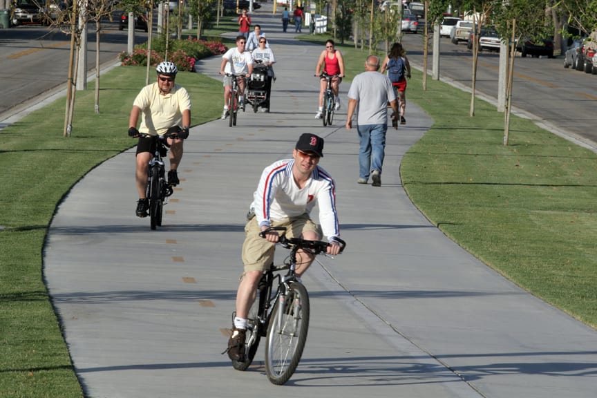 Landscaped, tree-lined Chandler Bikeway with separate bike and pedestrian lanes in Burbank's Magnolia Park neighborhood near Los Angeles.
