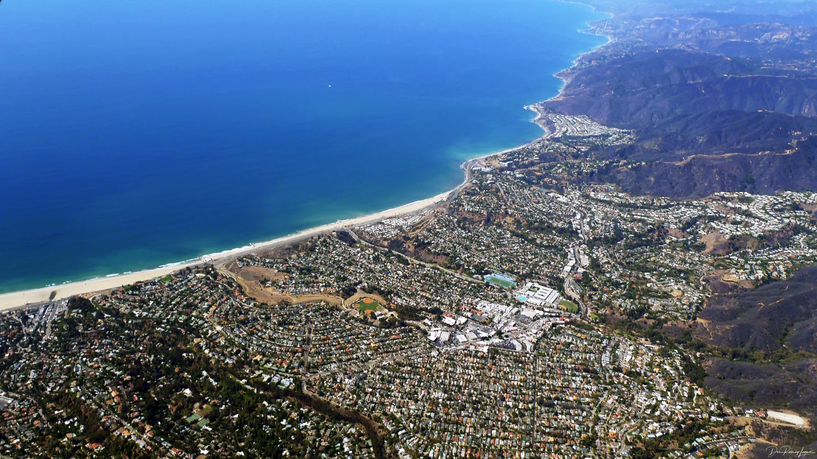 Coastal bluffs above Pacific Coast Highway in Pacific Palisades, Los Angeles, overlooking the ocean.