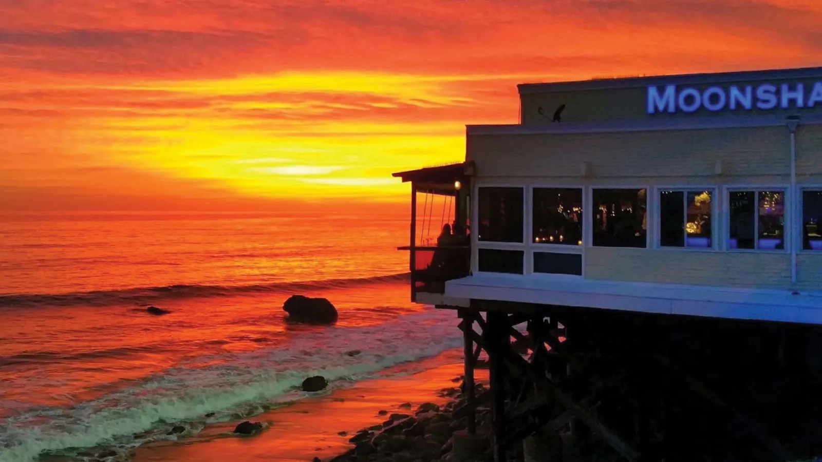 Moonshadows Restaurant on the beach with the sunset in the background