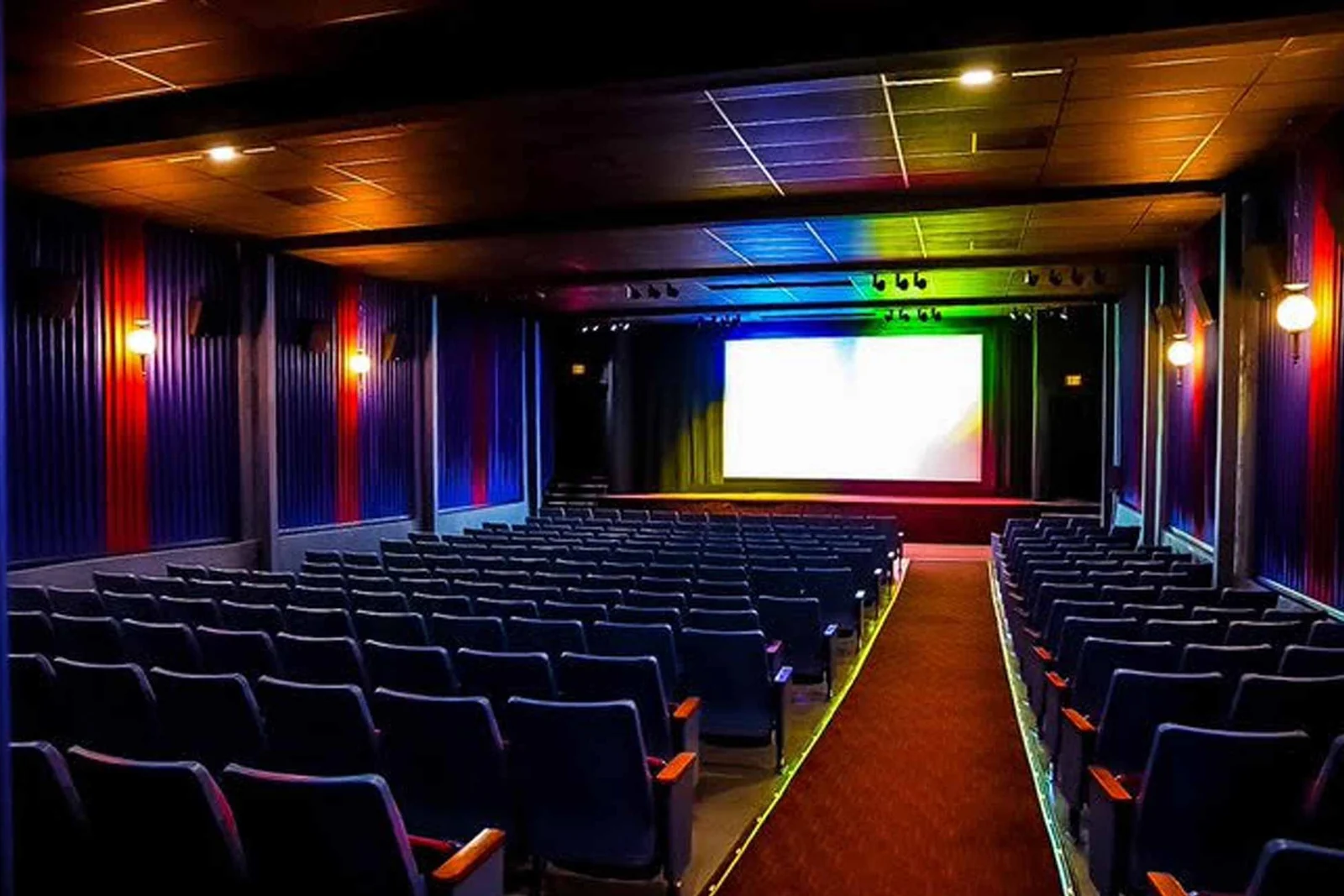 Rows of seats facing the screen inside the New Beverly Cinema