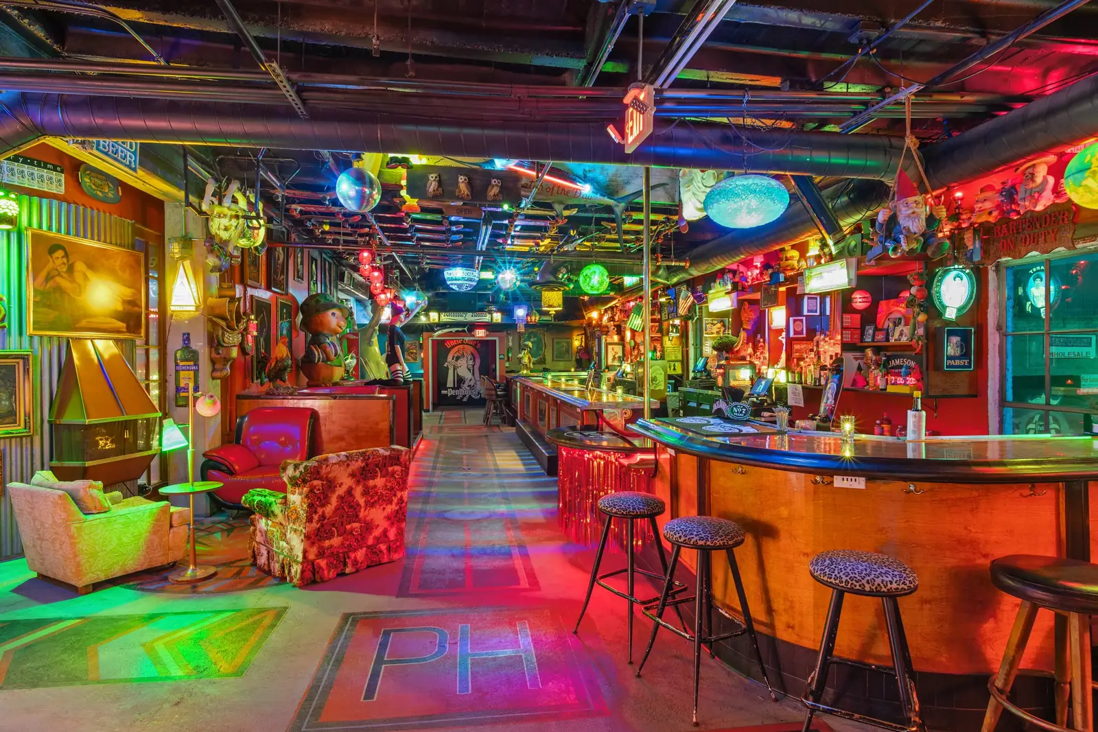 The neon-washed bar and lounge at Uncle Ollie's Penthouse