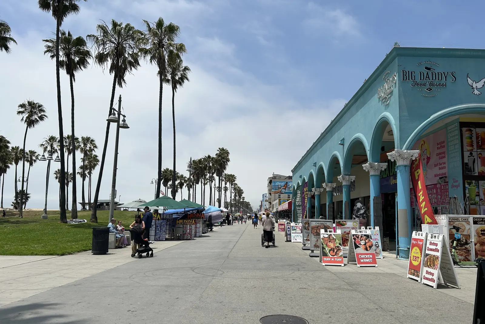 Palm trees and vendor stalls along the Venice Beach Boardwalk