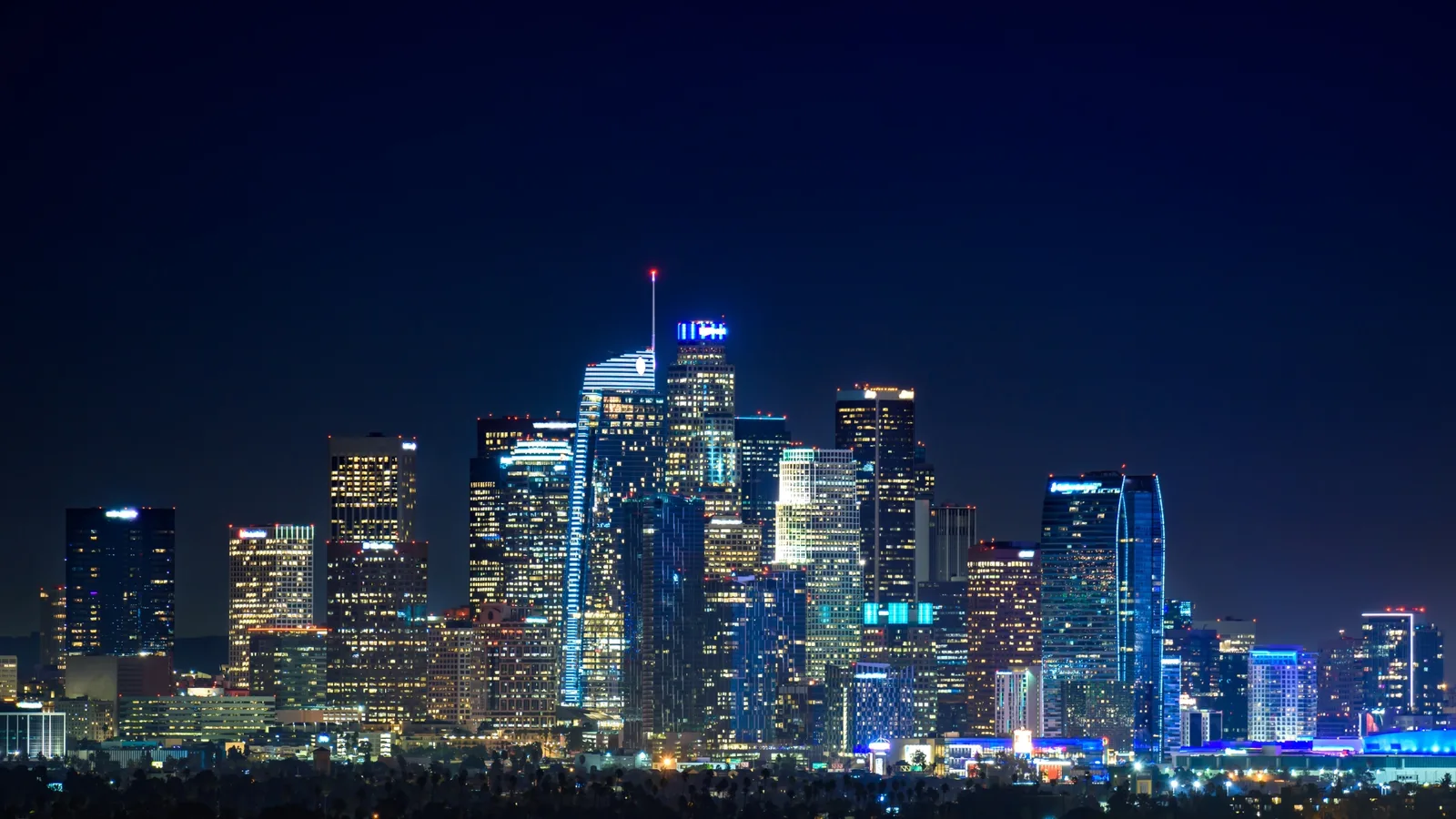 Los Angeles skyscrapers lit up at night under a clear sky