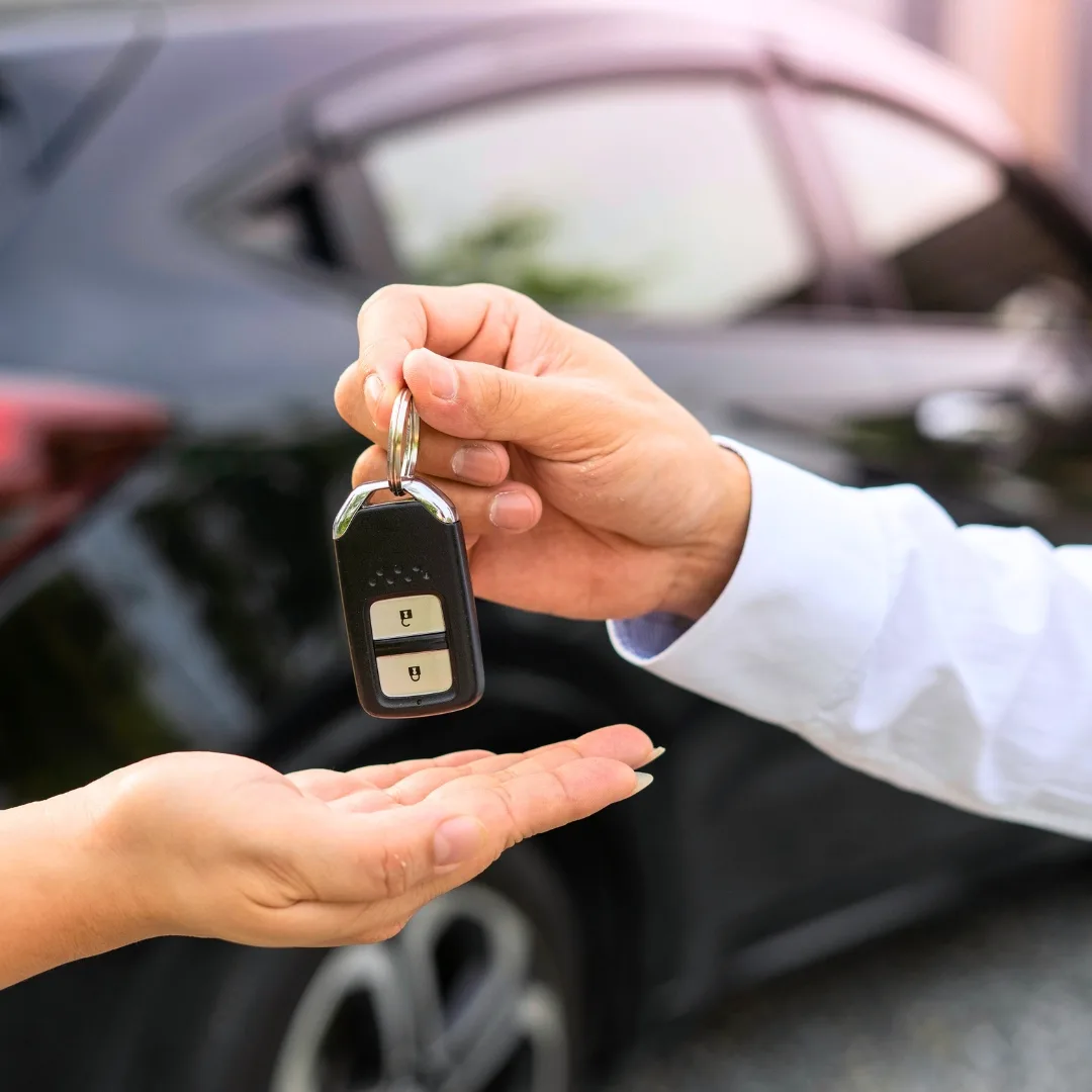 Rental car attendant handing keys to a tourist in Los Angeles