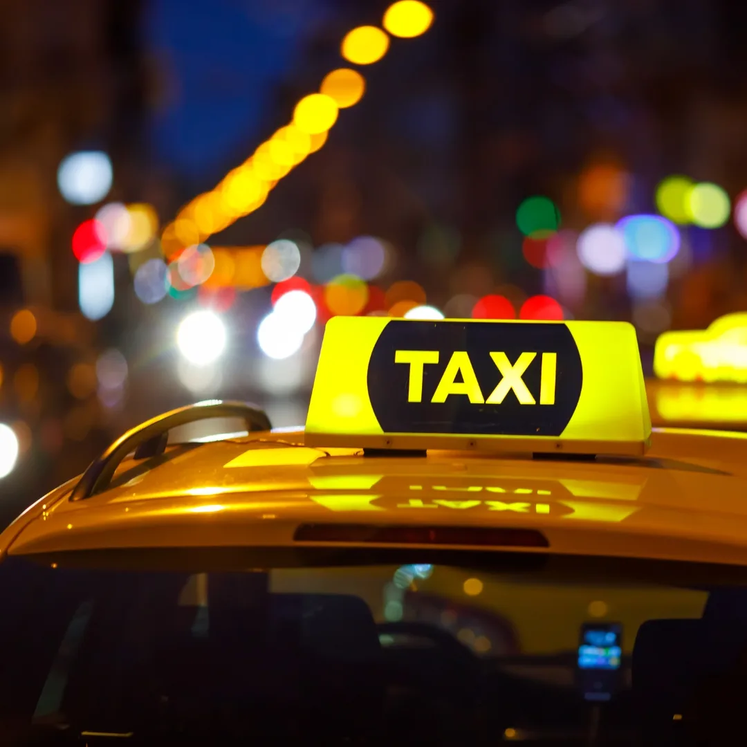 Los Angeles taxi cab light at night with colorful lights out of focus in the background