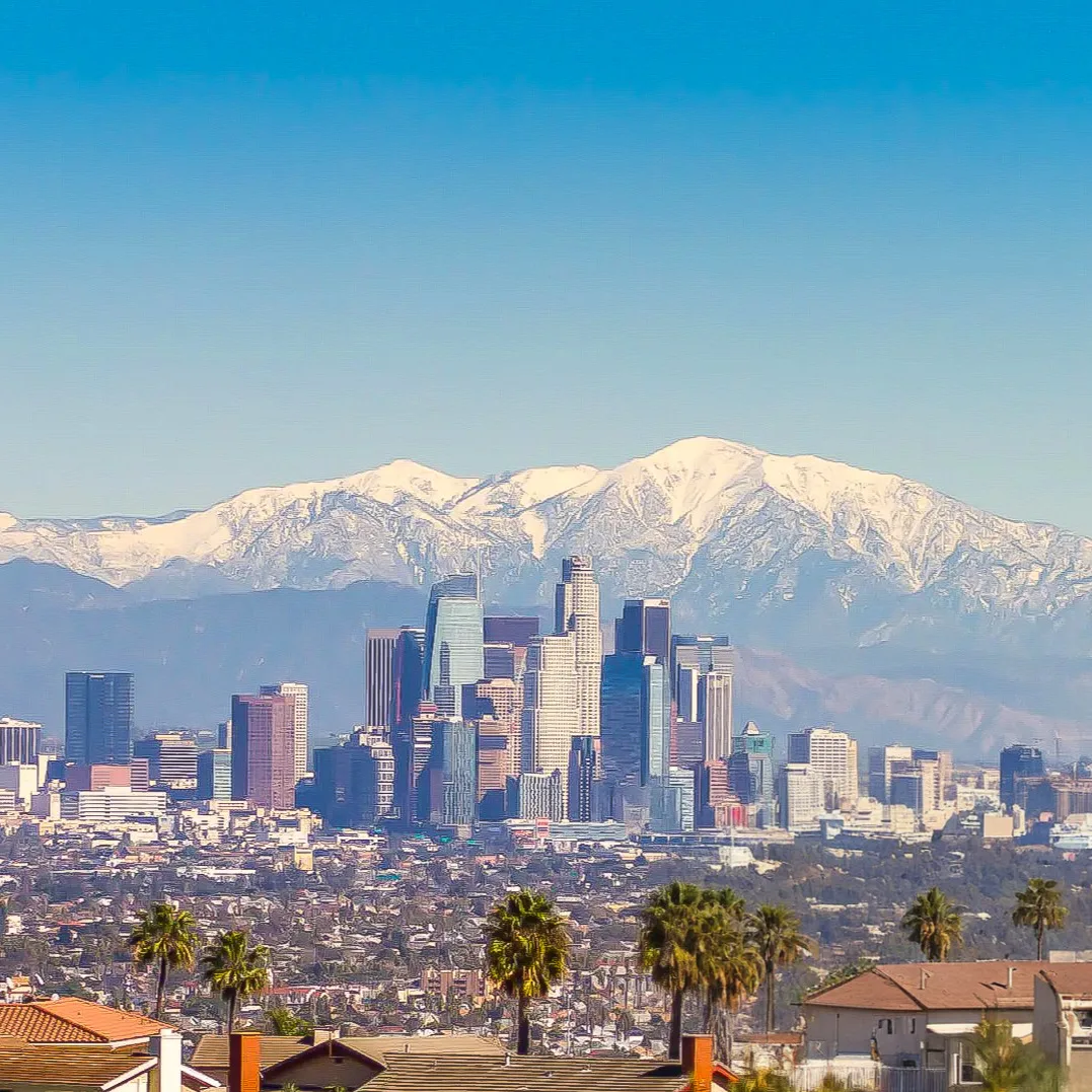 Downtown Los Angeles skyline with the snow-capped San Gabriel Mountains in the background