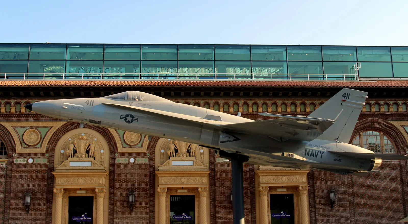 Mounted F/A-18 Hornet jet outside the historic brick façade of the California Science Center in Exposition Park