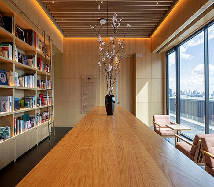 Interior lounge and library space at Japan House LA, overlooking the Los Angeles skyline.