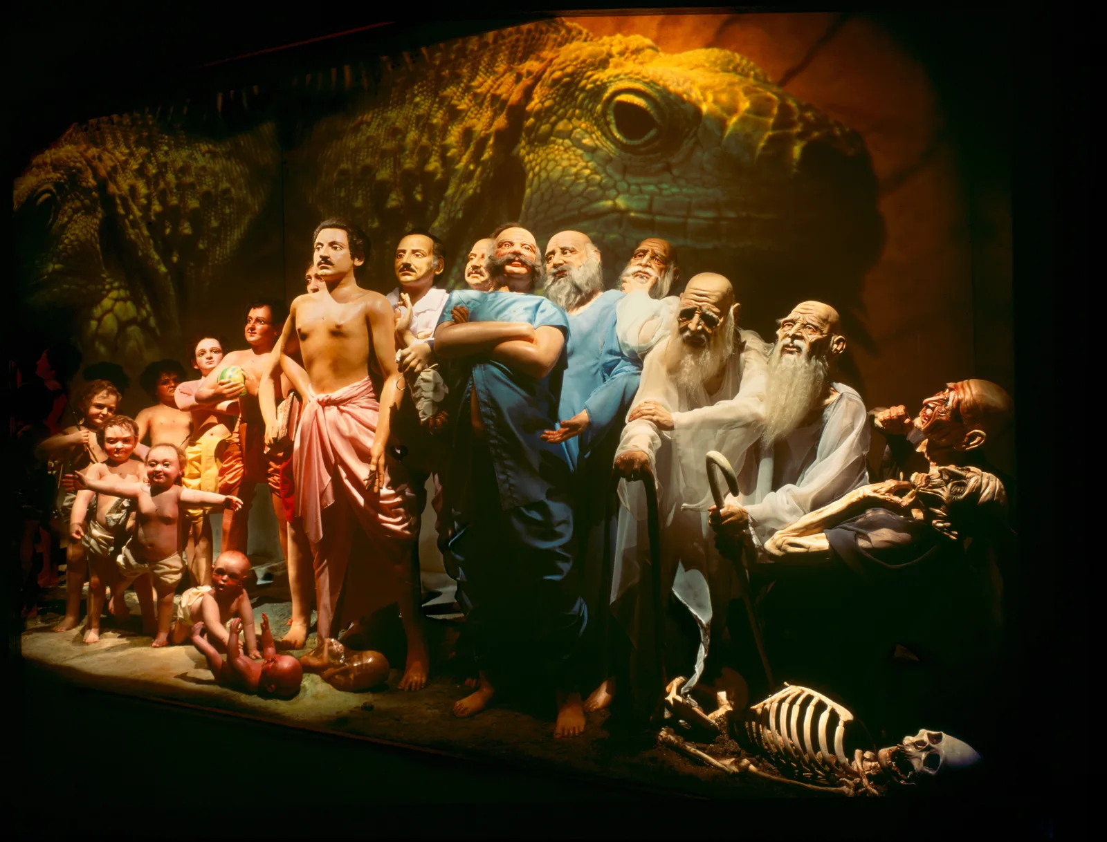 A lit diorama of robed figures in a darkened gallery