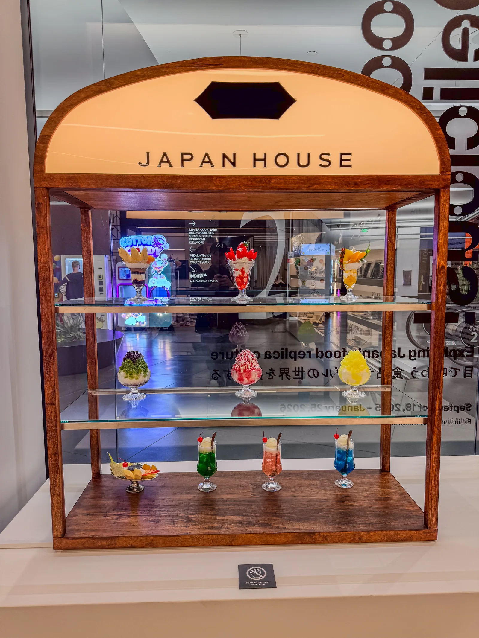 A woman viewing food art on display at JAPAN HOUSE LA at Ovation Hollywood