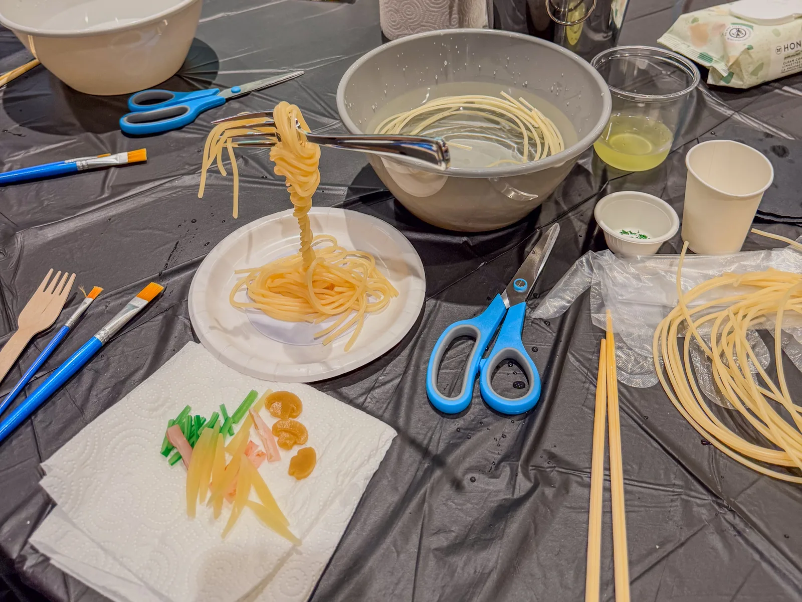 People viewing fake food art on display.