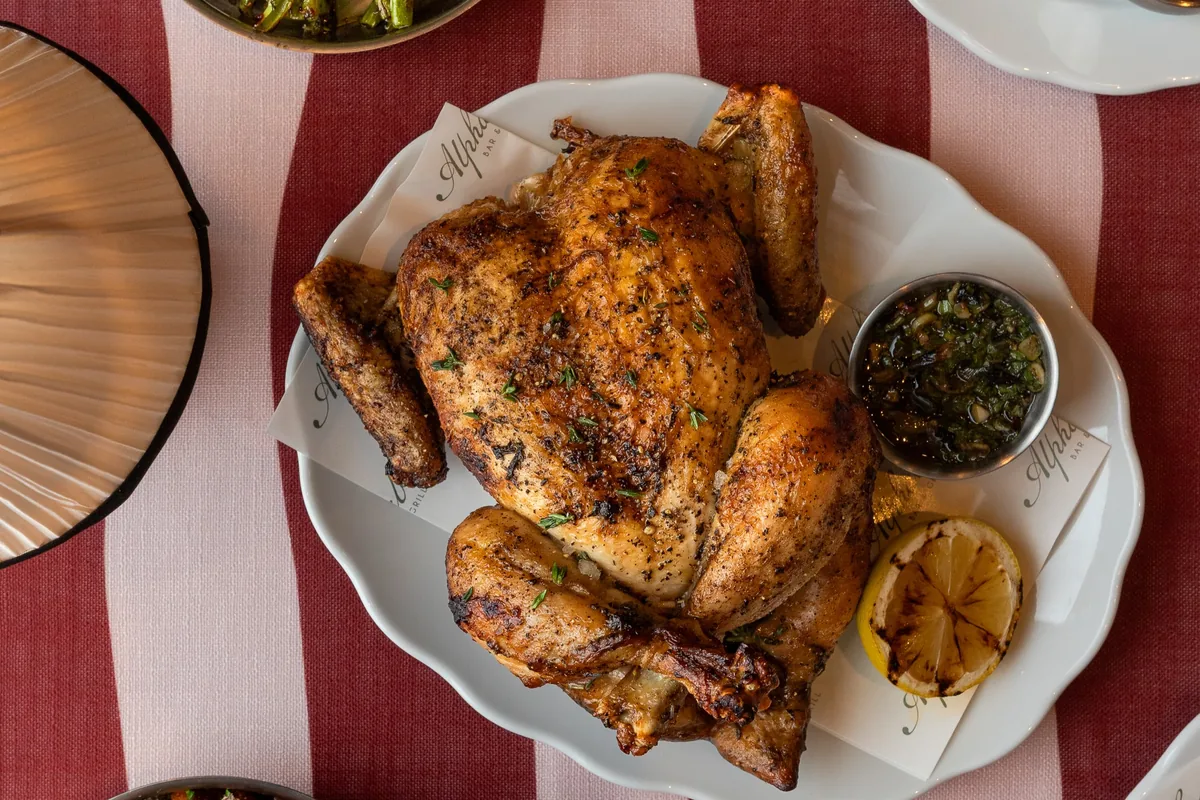 Whole rotisserie chicken with sides at Alphabet Bar & Grill in Palisades Village