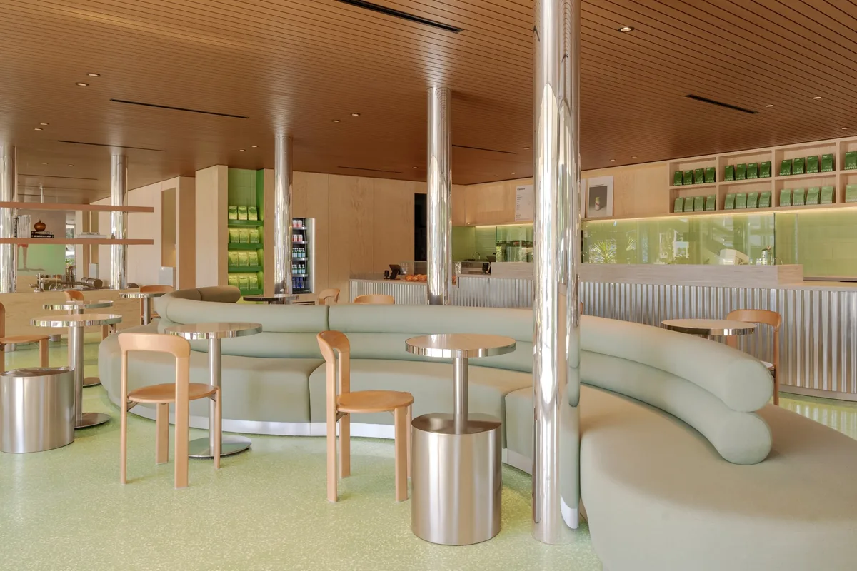 Wave booths and chrome tables inside Blank Street Coffee in Studio City