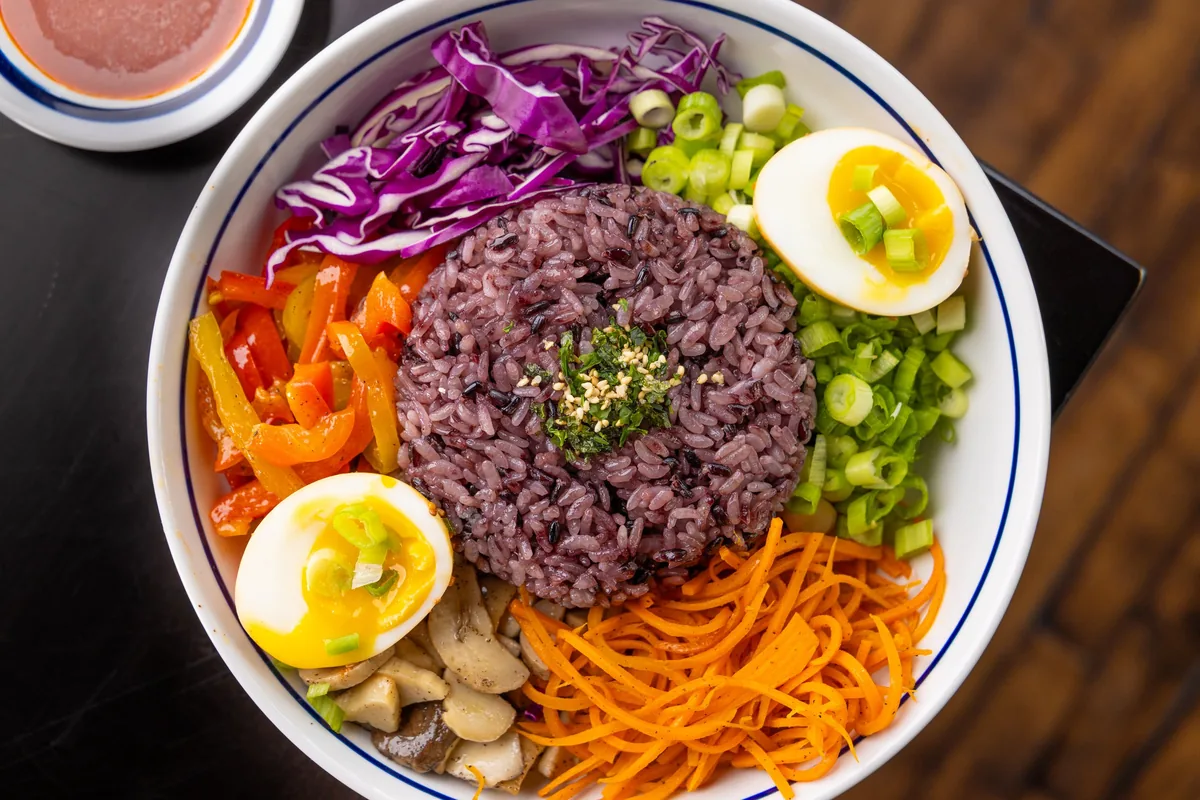 A purple rice bowl with egg and vegetables at Mokja in Highland Park