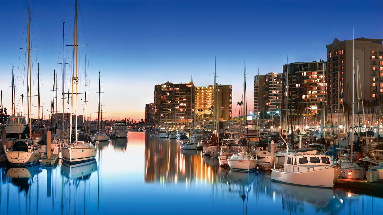 Marina del Rey's harbor at evening with boats and skyscrapers