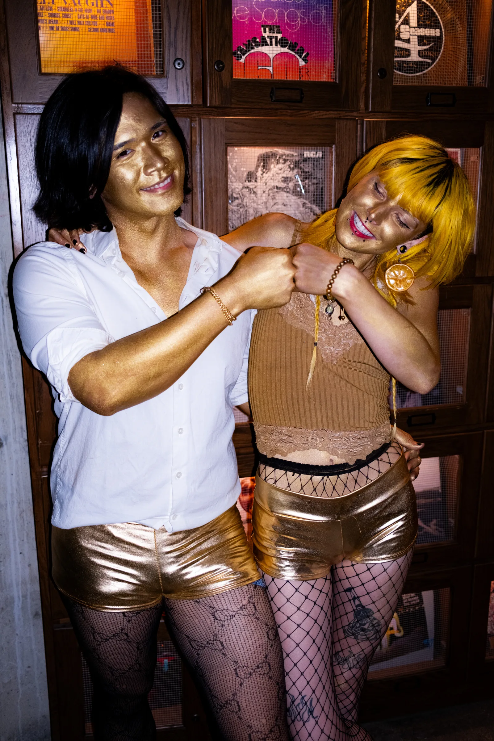 Two guests dance together, one in a white shirt, one in gold
