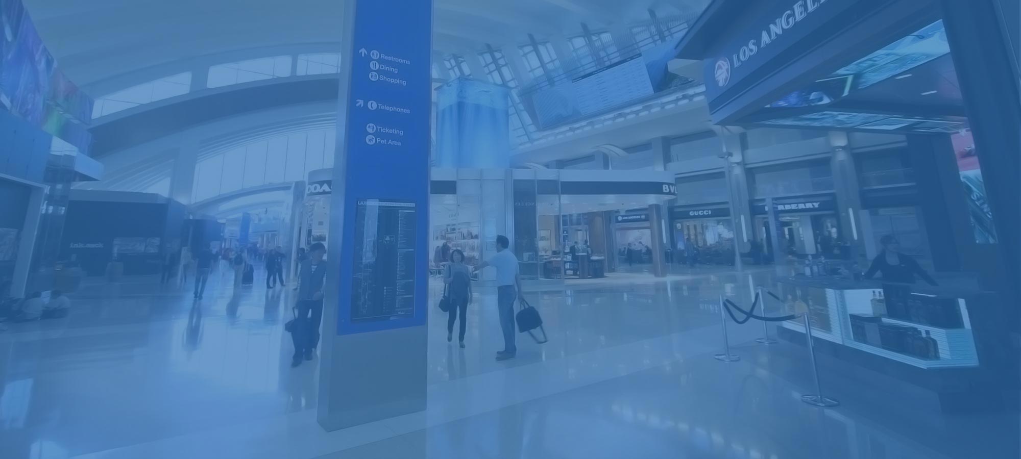 Retail shops including Gucci and Burberry inside a Los Angeles International Airport terminal.