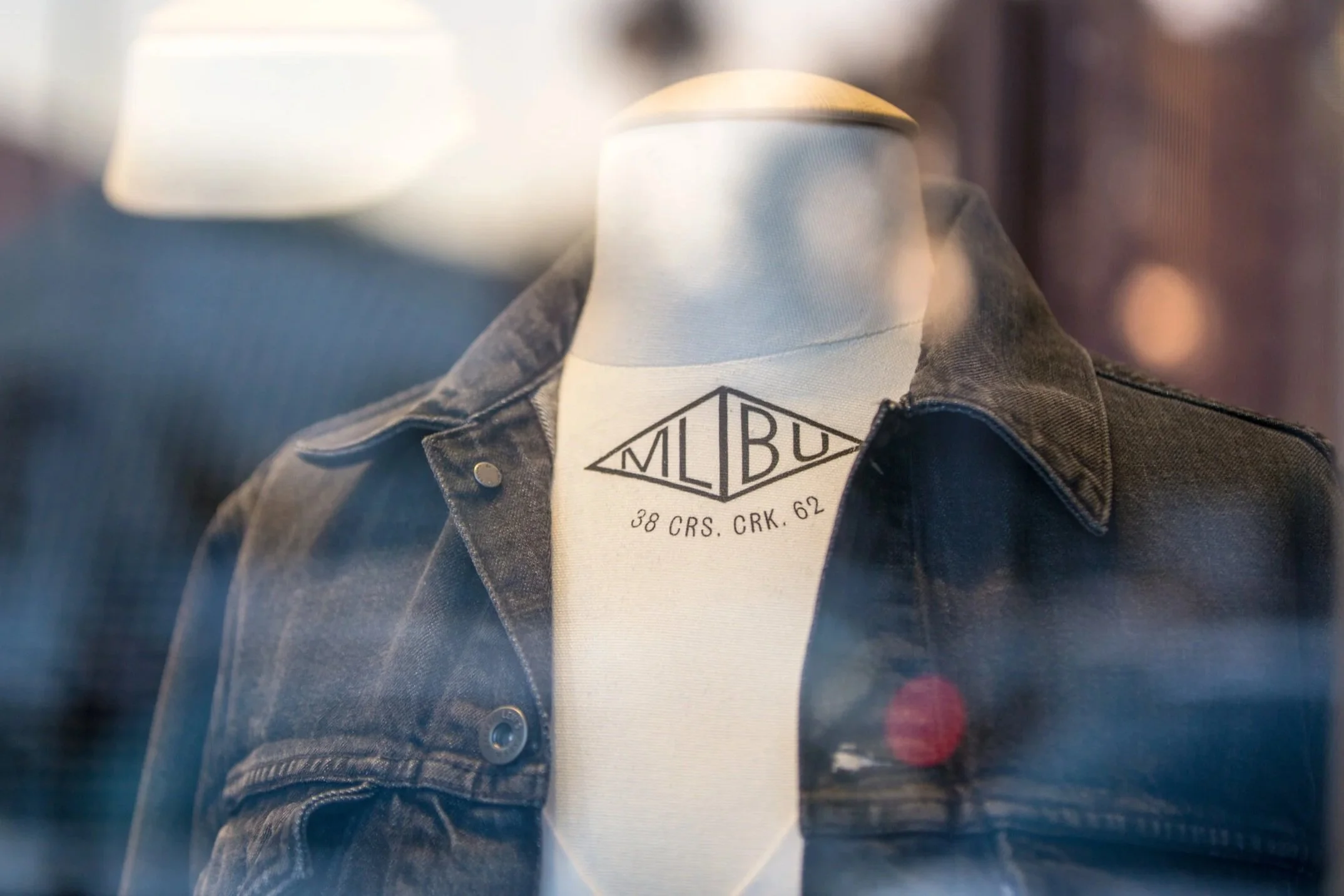 A denim jacket in a shop window at Malibu Village on Cross Creek Road.