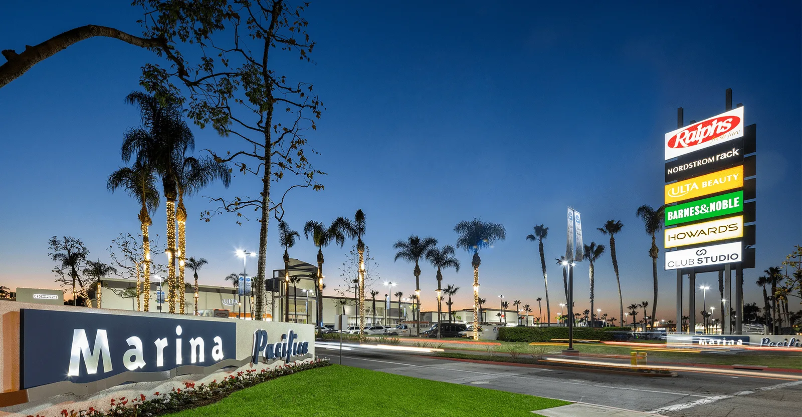 The Marina Pacifica shopping center sign at dusk in Long Beach.