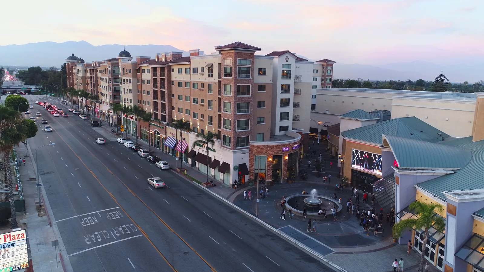 Atlantic Times Square, a mixed-use retail and residential building in Monterey Park, at dusk.
