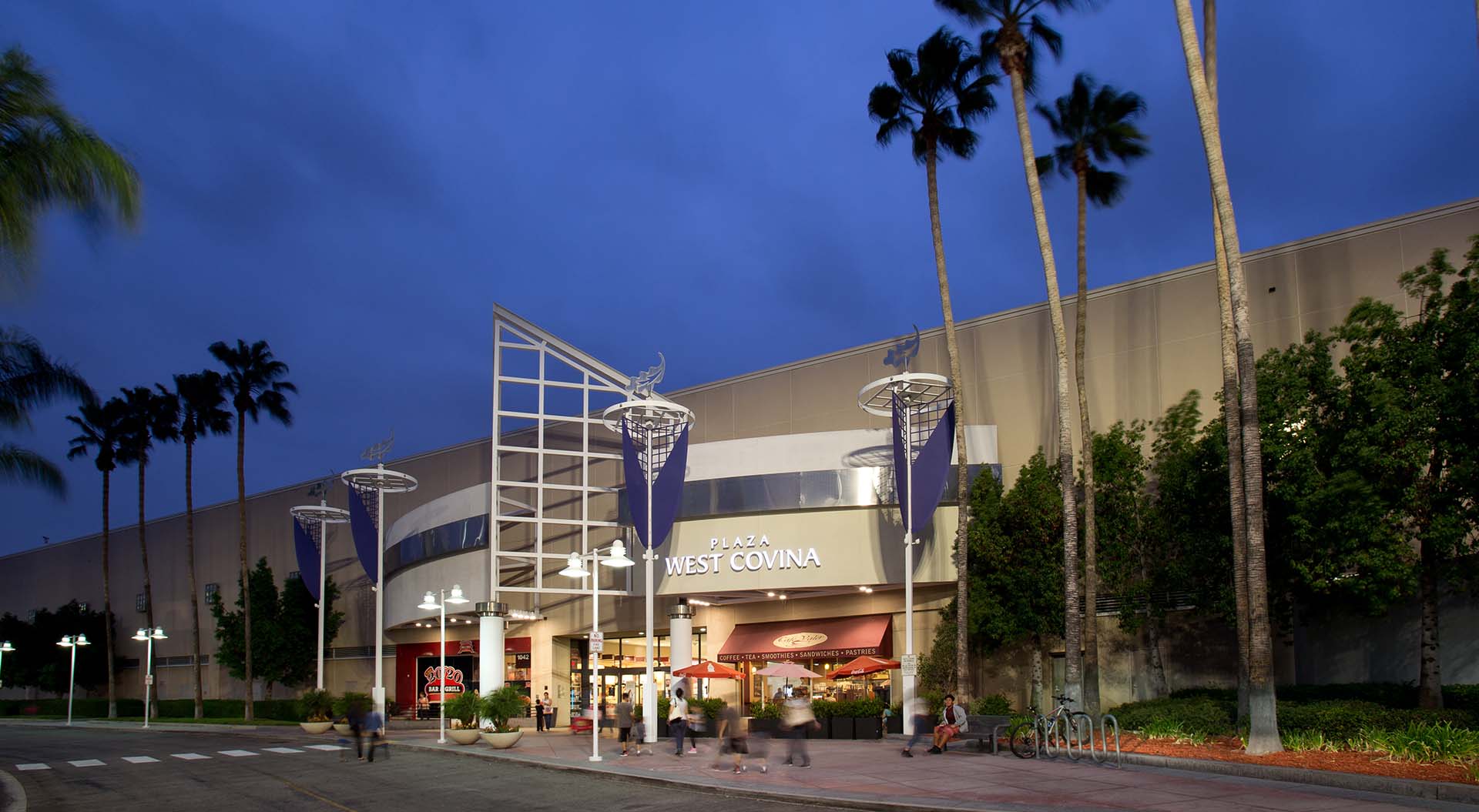 The Plaza West Covina shopping mall entrance sign at dusk.