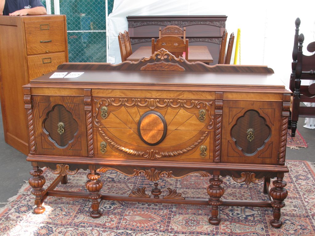 Antique furniture for sale at a vendor booth at the Rose Bowl Flea Market.